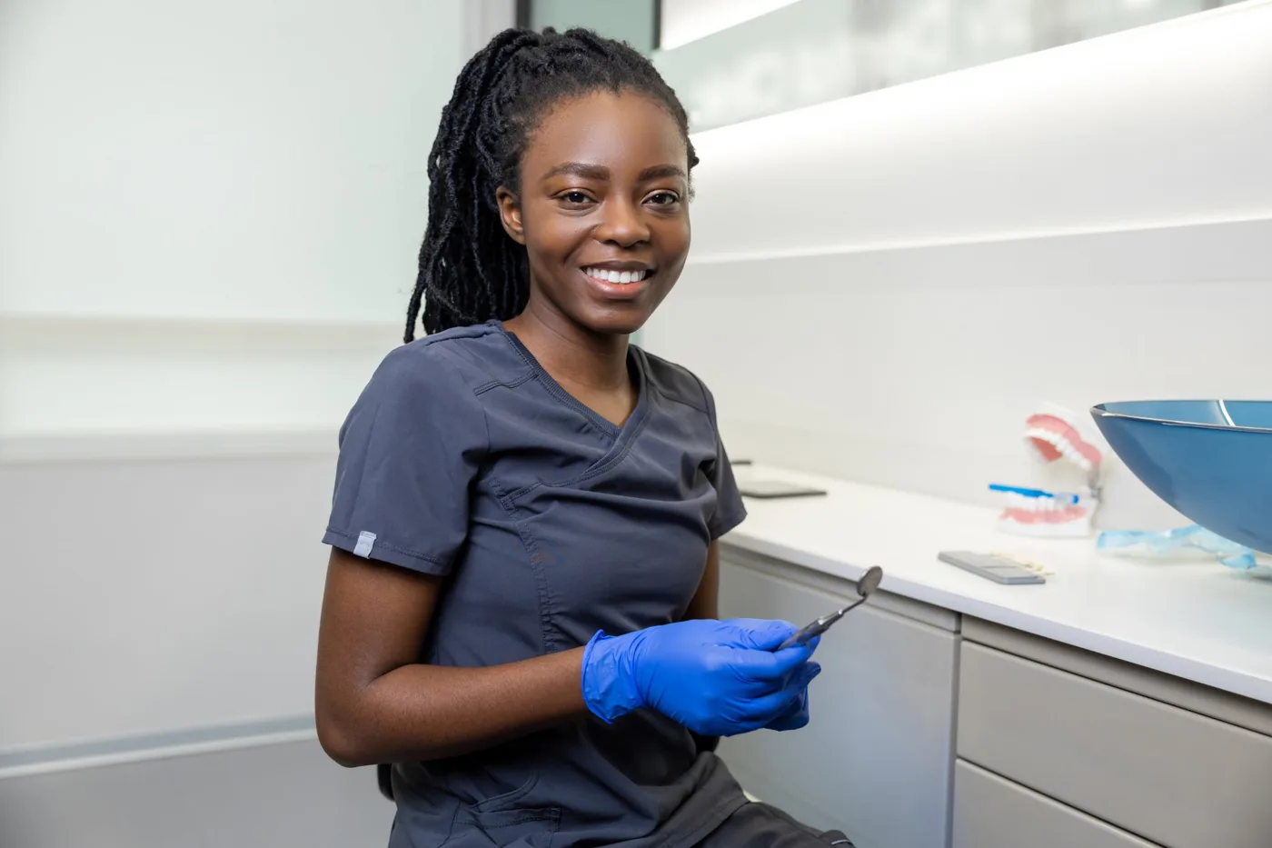 Smiling dentist in her clinic