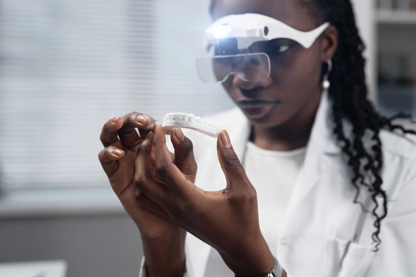 Lab technician inspecting a prosthesis